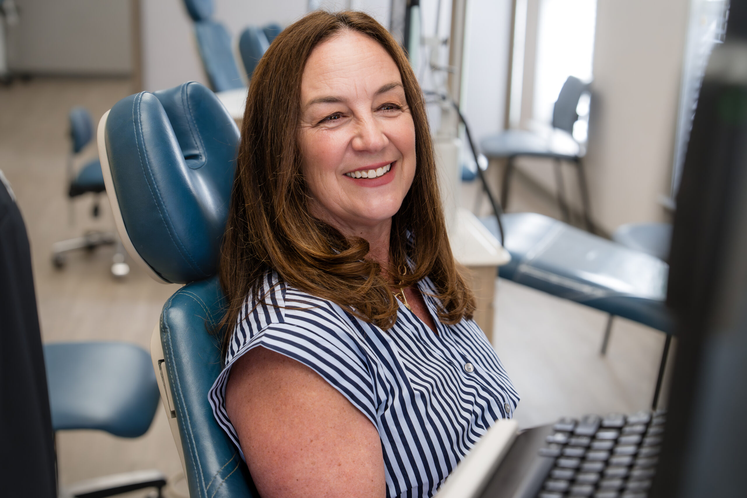 Adult smiling at orthodontic appointment