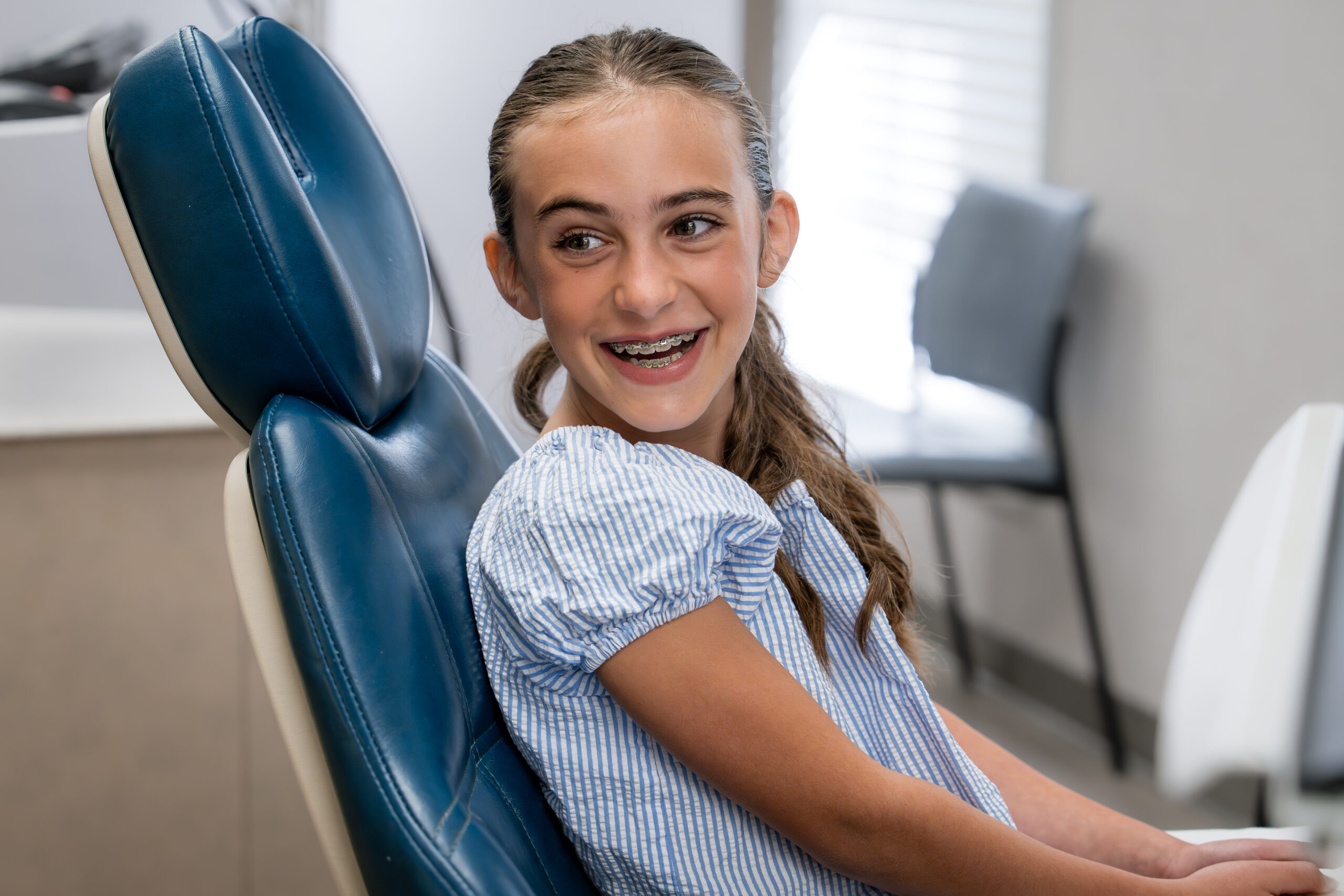 teen girl smiling at orthodontic appointment