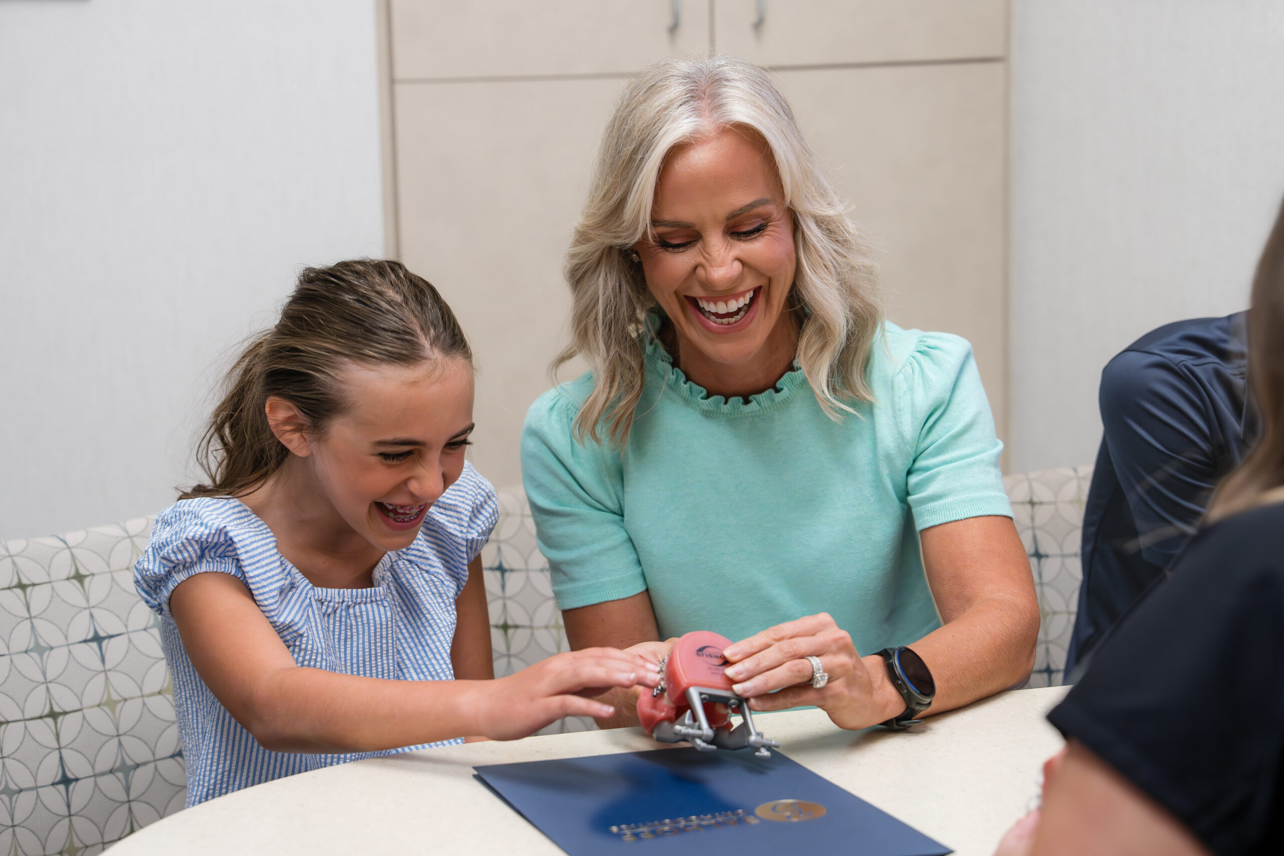 mother and daughter smiling at consultation