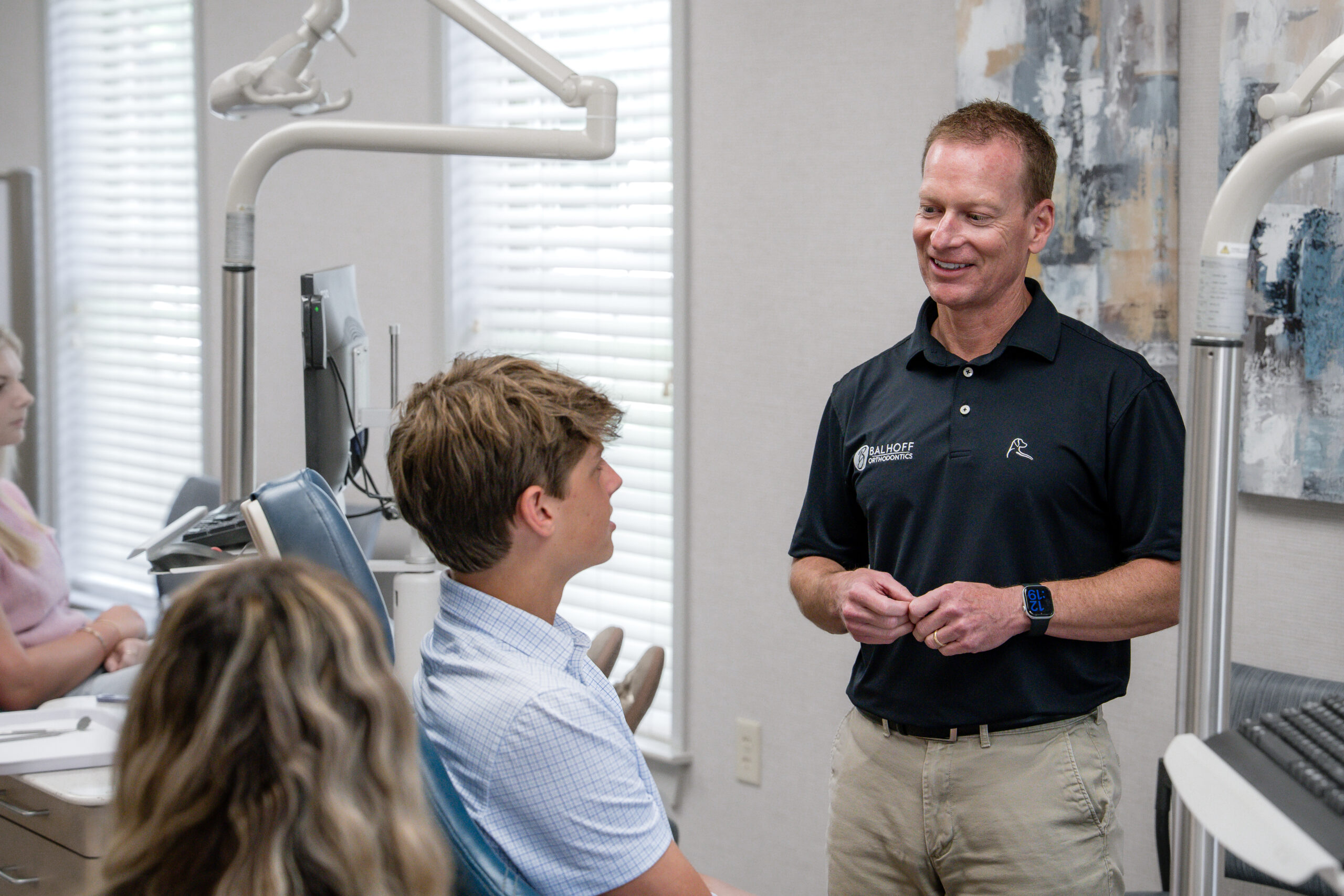 Dr. Balhoff talking to teen patient